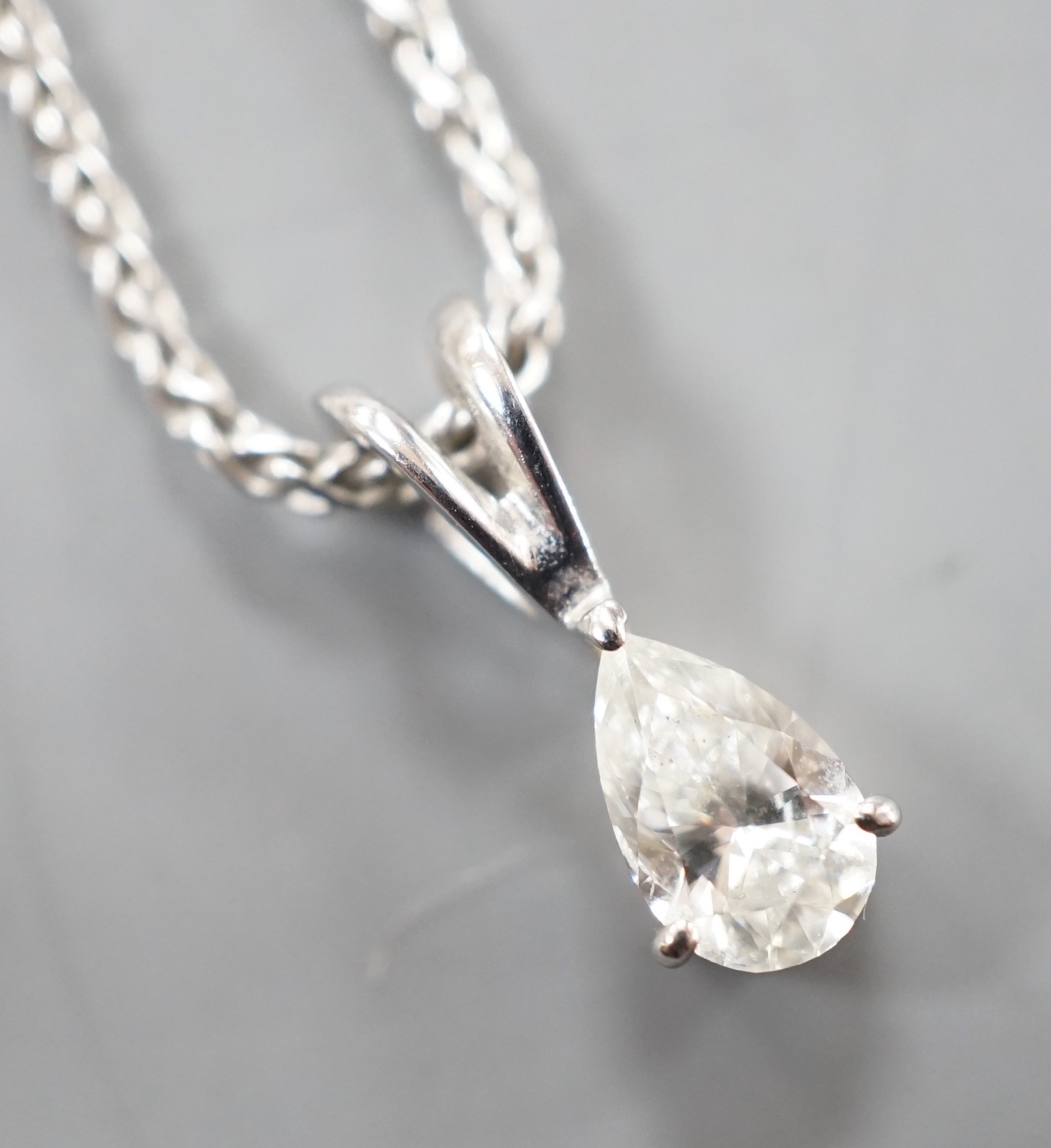 A modern white metal and pear cut diamond set pendant, 13mm, on an 18ct white gold chain, 39cm, gross weight 4.5 grams.